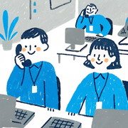 A cartoon image of two workers with name badges working in an office, one on the phone A cartoon image of two workers with name badges working in an office, one on the phone